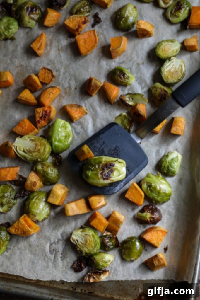 Midnight Sesame Noodle Bowl 8 Roasted brussels sprouts and sweet potato on a parchment-lined baking sheet, golden and tender.