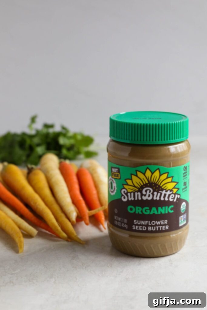 SunButter jar with rainbow carrots and cilantro on board