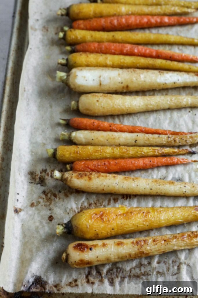 Rainbow carrots roasted on parchment lined baking sheet